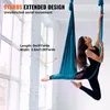 A woman is performing aerial yoga in a studio with large windows. Voir les images du produit