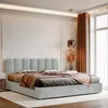 A modern bedroom interior featuring a bed with a padded headboard and draped bedding. Anteprima dell’immagine prodotto