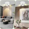 Two split images showing a modern white ceiling light fixture in different room settings: a living room with a gray sectional sofa and a dining room with a table set for a meal. Náhľad obrázku produktu
