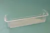 A clear plastic refrigerator door shelf is shown against a teal background. Produktbild-Vorschau