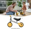 A woman is showing a balance bike to a child indoors. Anteprima dell’immagine prodotto