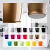 A collage of various colored flower pots with saucers, and close-ups of a gold pot. Produktbild-Vorschau