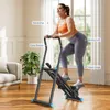 A woman is using a stepper machine in a living room. Náhled obrázku produktu