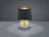 A table lamp with a black shade and a gold interior sits on a gray surface against a gray background. Náhled obrázku produktu