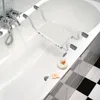 A bathtub with a bath seat installed over the edge. Voir les images du produit