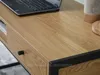 Close-up of a wooden desk with a laptop and a drawer. Podgląd zdjęcia produktu