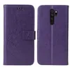 A purple flip phone case with floral and butterfly embossing is shown from the front and back. Produktbild-Vorschau