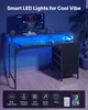 A gaming desk setup with a computer, keyboard, mouse, and headphones, illuminated by blue LED lights. Podgląd zdjęcia produktu