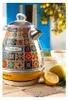 A decorative kettle is shown on a stone surface with lemons and cups of tea, set against a backdrop of blue shutters and a lemon tree. Náhled obrázku produktu
