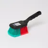 A cleaning brush with a black handle and red and green bristles, shown against a white background. Produktbild-Vorschau
