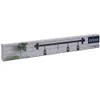 The image shows the packaging of a kitchen utensil rack against a white background. The packaging features a graphic of a brick wall with ivy and a black metal rack with hooks. Anteprima dell’immagine prodotto