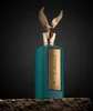 A luxurious perfume bottle with a gold eagle figurine on top, set against a dark background. Podgląd zdjęcia produktu