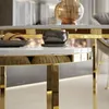 Close-up of a modern round coffee table with a white marble top and gold accents. Náhľad obrázku produktu
