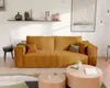 A modern living room with a mustard yellow corduroy sofa, coffee tables, and a framed poster on the wall. Náhled obrázku produktu