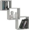 A set of three interlocking cube-shaped wall shelves, displaying books and decorative vases. Náhľad obrázku produktu