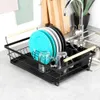 A dish drying rack with plates and glasses next to a sink. Náhľad obrázku produktu