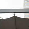 A close-up view of the top of a pergola or awning, showing a metal track and a fabric canopy attached with a hook. Voir les images du produit