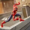 A Spider-Man action figure is posed dynamically on a rooftop ledge, with buildings in the background. Podgląd zdjęcia produktu