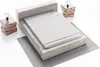 A bed with a headboard, mattress, and two bedside tables with lamps, set against a white background. Náhled obrázku produktu