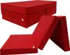 Two views of a red folding mattress, one stacked and one unfolded. Voir les images du produit
