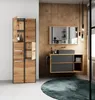 A modern bathroom vanity and cabinet set with a wooden finish and dark gray drawers, set against a wood-paneled wall. Podgląd zdjęcia produktu