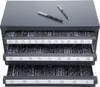 A metal organizer cabinet with three drawers filled with drill bits, with two drill bits lying on top. Náhled obrázku produktu