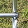 A close-up view of a metal frame joint with a bolt and nut, set against a blurred background of grass. Náhľad obrázku produktu