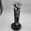 A Philips electric shaver is displayed on a charging stand against a plain background. Podgląd zdjęcia produktu