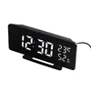 A digital alarm clock with a black casing and a reflective display showing the time, temperature, and humidity. Produktbild-Vorschau