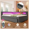 A modern gray daybed with LED lighting and a remote control, set in a bedroom. Voir les images du produit