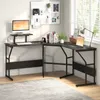 A black L-shaped desk with a monitor stand, keyboard, and various office supplies is set up in a room with a window and blinds. Anteprima dell’immagine prodotto