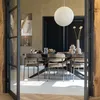 A dining room scene with a table and chairs, set for a meal. Produktbild-Vorschau