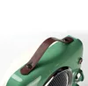 A close-up shot of the top part of a vintage-style heater, focusing on the handle and the green casing. Náhled obrázku produktu