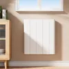 A white electric heater mounted on a light beige wall, next to a wooden cabinet. Náhľad obrázku produktu