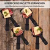 Several raclette pans filled with cheese, meat, and pickles are arranged on a wooden surface. Produktbild-Vorschau