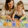 A mother and child are playing with learning cards on the floor. Produktbild-Vorschau