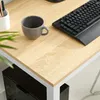 A close-up view of a desk with a keyboard, a mug, and a plant. Produktbild-Vorschau