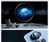 An astronaut sitting on the moon looking at Earth through a circular portal, with a close-up of a phone camera lens below. Náhľad obrázku produktu