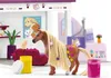 A toy horse is being groomed and decorated in a salon-like setting. Produktbild-Vorschau