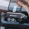 A hand is placing a smartphone into a car phone holder mounted on a car's air vent. Náhľad obrázku produktu