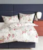 A bed with a duvet cover and pillowcases featuring a snowman pattern, set against a dark blue headboard and a red nightstand. Produktbild-Vorschau