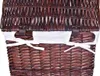 Close-up view of the top part of a woven basket with a white fabric lining and ties. Produktbild-Vorschau