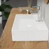A close-up shot of a modern white rectangular sink with a chrome faucet on a wooden countertop. Náhľad obrázku produktu