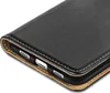 A close-up view of the corner of a black leather flip phone case, showing the stitching and the interior lining. Produktbild-Vorschau