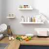 A kitchen counter with various items including shelves, vegetables, and a toaster. Produktbild-Vorschau