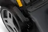 A close-up view of a lawnmower's wheel and handle. Produktbild-Vorschau