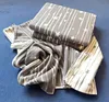 A folded and unfolded blanket with a star pattern on a blue surface. Produktbild-Vorschau