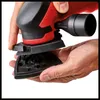 Hands are shown attaching a triangular sanding pad to a red and black power sander. Náhľad obrázku produktu