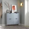A modern hallway with a light gray shoe cabinet, artwork, and a wall sconce. Náhľad obrázku produktu