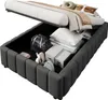 A bed frame with its storage compartment open, revealing various items stored inside. Produktbild-Vorschau